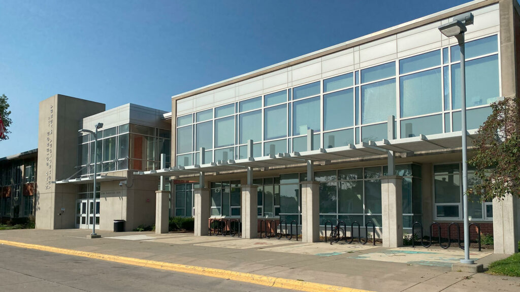 Exterior photo of the King Science school building. The building front has many glass windows with bike racks lined up out front.