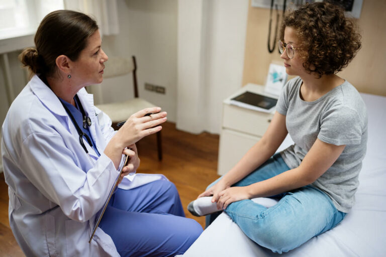 Doctor checks up on her teen patient.